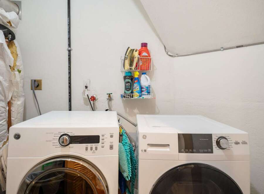 This laundry room features two modern GE appliances, a washer and a dryer, side-by-side for efficient chore management.