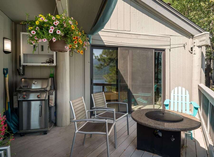 Enjoy outdoor living on this spacious deck, complete with a stainless steel grill for summer barbecues and a stone fire pit for cozy evenings.