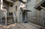 Discover this charming property featuring a welcoming wooden deck and a sturdy staircase leading to the entrance.