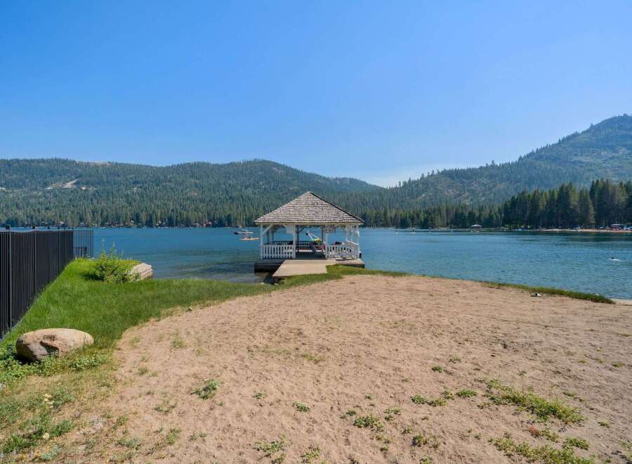 Enjoy direct lake access from this stunning property featuring a private gazebo and sandy beach area.