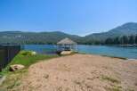 Enjoy direct lake access from this stunning property featuring a private gazebo and sandy beach area.