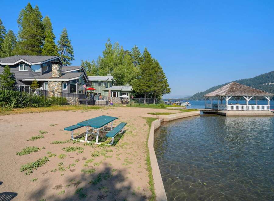Enjoy lakeside living with this stunning property featuring a private beach and a charming gazebo perfect for relaxing by the water.