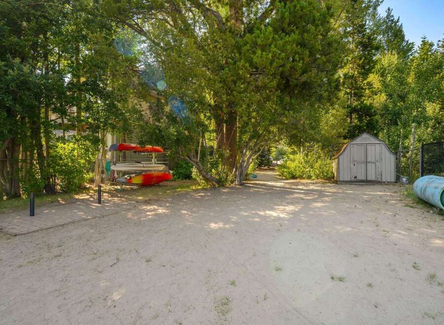 This property offers a fantastic outdoor living space with kayaks ready for adventure and a convenient storage shed for your gear.