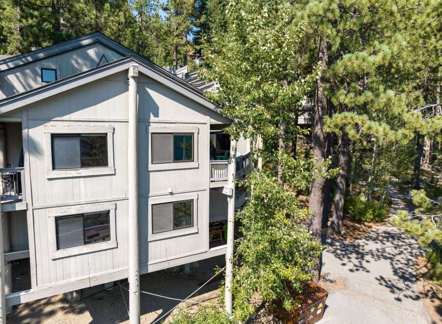 Nestled amongst tall pine trees, this multi-level home offers a serene mountain retreat.