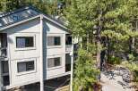 Nestled amongst tall pine trees, this multi-level home offers a serene mountain retreat.