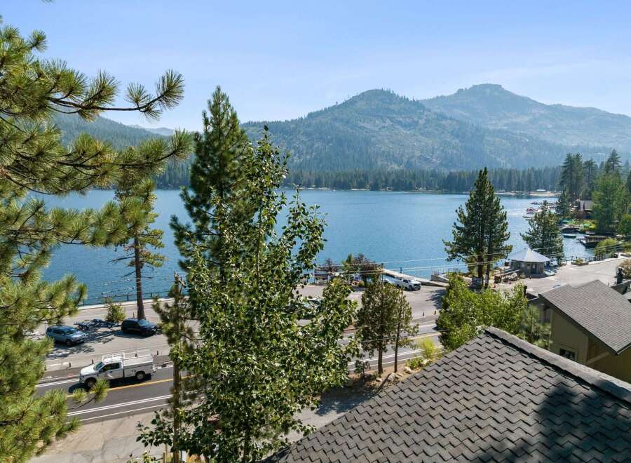 Experience breathtaking lakefront living with this stunning property offering panoramic views of the sparkling blue water and majestic mountains.