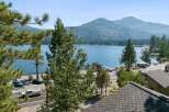 Experience breathtaking lakefront living with this stunning property offering panoramic views of the sparkling blue water and majestic mountains.