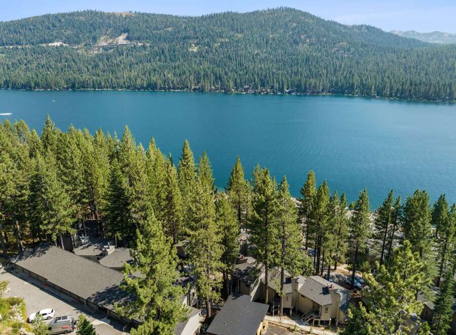 Experience the ultimate lakeside living with this stunning property nestled among towering pine trees.