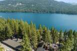 Experience the ultimate lakeside living with this stunning property nestled among towering pine trees.
