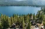 Experience the ultimate lakeside living with this stunning property offering breathtaking views of the crystal-clear blue water and surrounding lush green mountains.