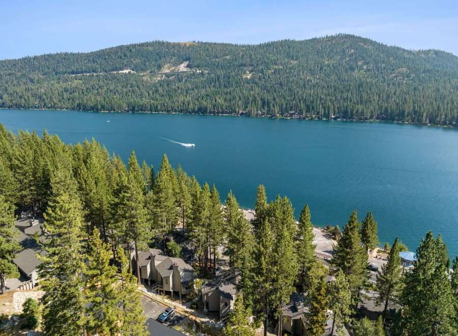 Experience breathtaking lakefront living with this stunning property nestled among towering pine trees.