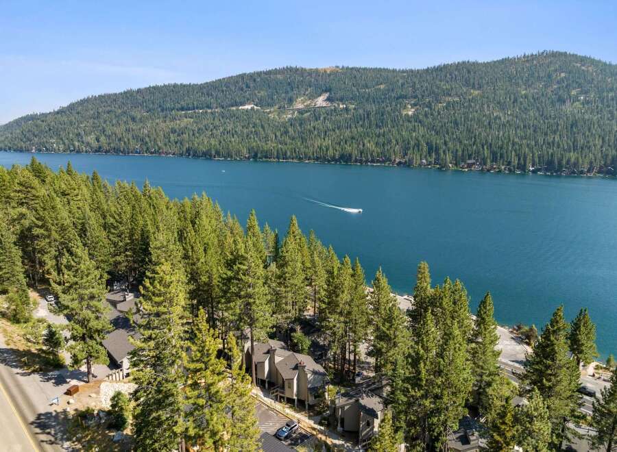 Experience breathtaking lake views from this stunning property nestled among tall pine trees.