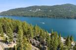 Experience breathtaking lake views from this stunning property nestled among tall pine trees.