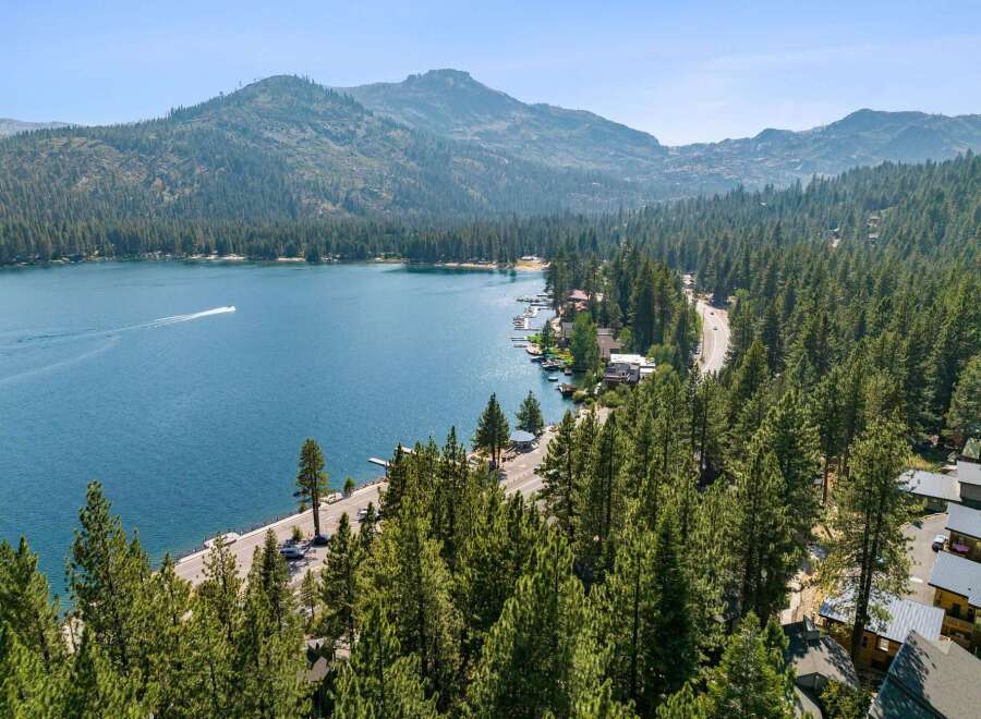 Experience the ultimate lakeside living with this stunning property offering breathtaking views of the pristine blue water and surrounding mountains.