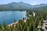 Experience the ultimate lakeside living with this stunning property offering breathtaking views of the pristine blue water and surrounding mountains.