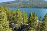Experience breathtaking lake views from this stunning property nestled amongst towering pine trees.