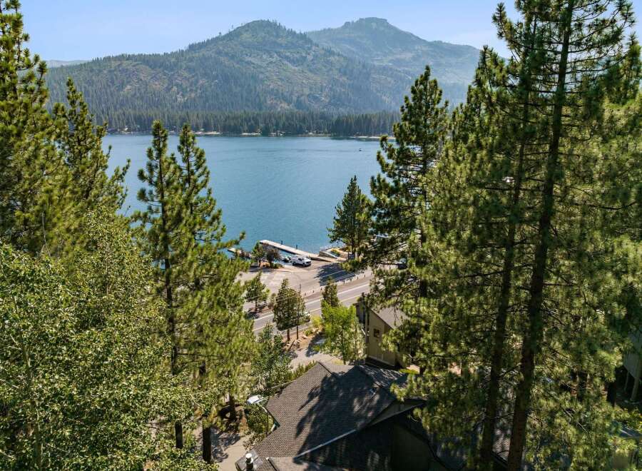 Experience breathtaking lake views from this stunning property, nestled amidst lush pine trees.