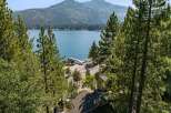Experience breathtaking lake views from this stunning property, nestled amidst lush pine trees.