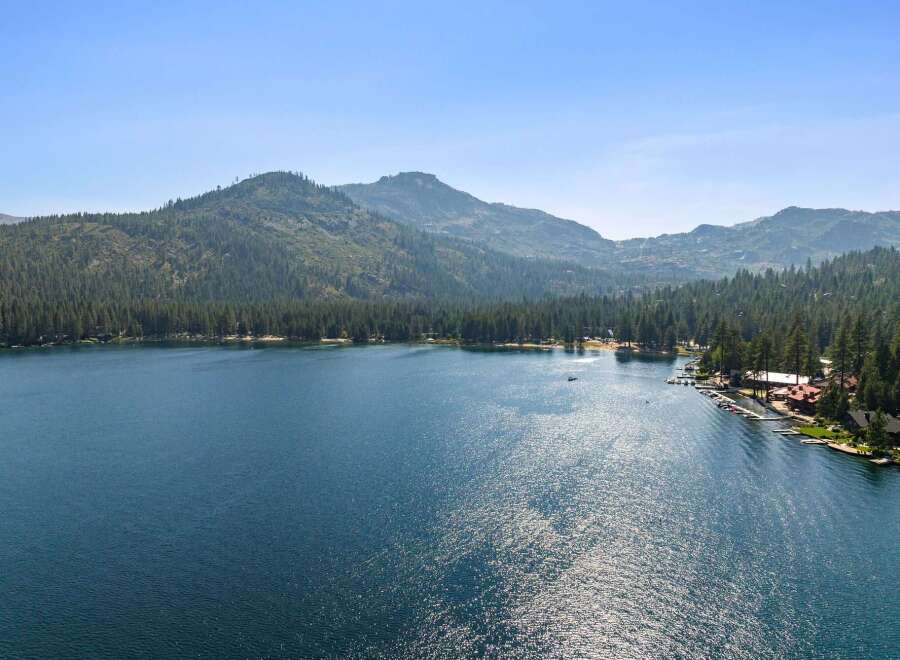 Experience the ultimate lakeside living with this stunning property offering direct access to a pristine lake and breathtaking mountain views.