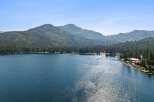 Experience the ultimate lakeside living with this stunning property offering direct access to a pristine lake and breathtaking mountain views.