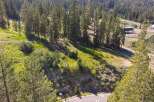 Discover this stunning property nestled amidst a lush pine forest, offering breathtaking natural beauty and serene mountain views.