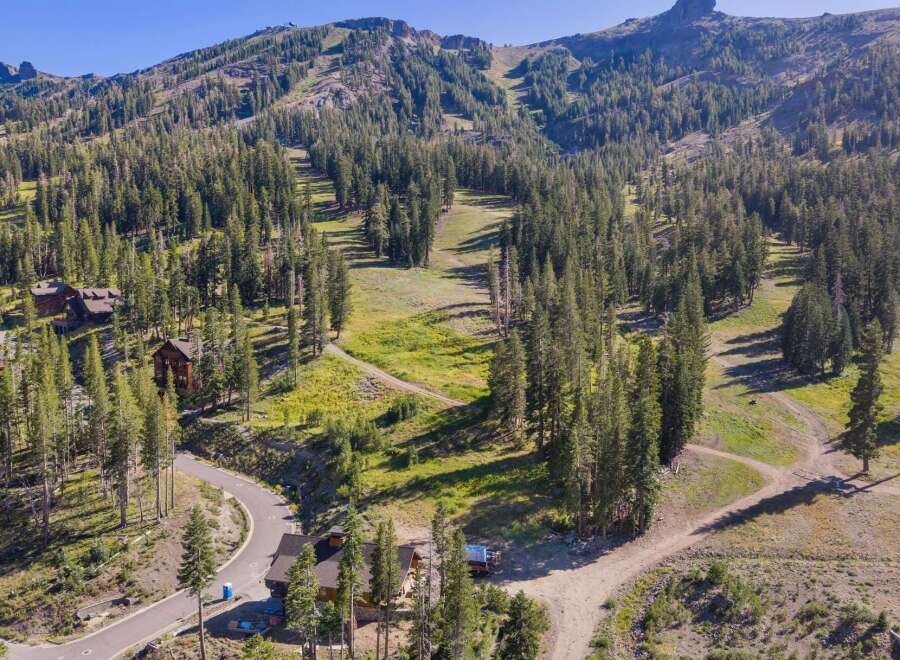 Nestled amidst a lush pine forest, this property offers a serene mountain retreat with stunning views of ski slopes and rugged peaks.