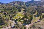 Nestled amidst a lush pine forest, this property offers a serene mountain retreat with stunning views of ski slopes and rugged peaks.