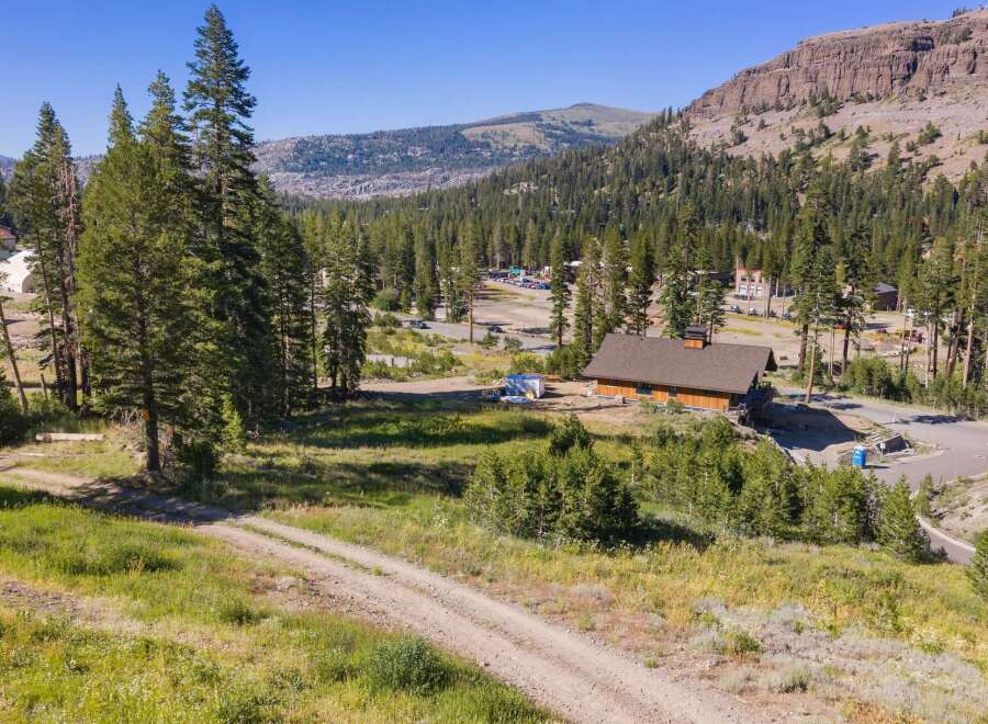 Nestled amidst towering pine trees and a majestic mountain backdrop, this property offers a serene escape.