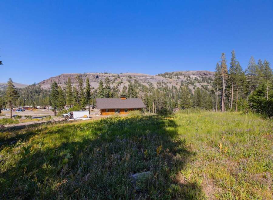 Nestled amidst a serene mountain landscape, this charming wooden cabin offers a tranquil retreat.