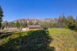 Nestled amidst a serene mountain landscape, this charming wooden cabin offers a tranquil retreat.