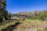 Nestled amidst towering pine trees and rolling meadows, this property offers a serene mountain escape.
