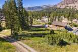 Nestled amidst a serene mountain landscape, this property offers a unique blend of natural beauty and potential.