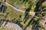 Discover this stunning property with a winding paved road leading to a secluded dirt path, perfect for outdoor adventures.