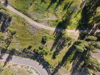 Discover this stunning property with a winding paved road leading to a secluded dirt path, perfect for outdoor adventures.