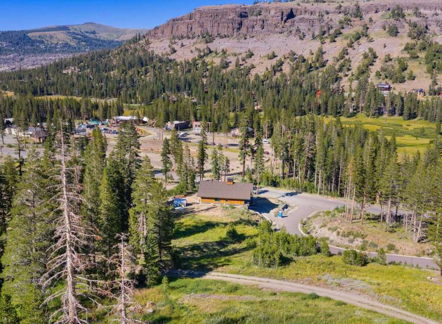Discover this stunning mountain property nestled amidst towering pine trees and rolling hills.