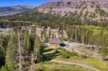 Discover this stunning mountain property nestled amidst towering pine trees and rolling hills.