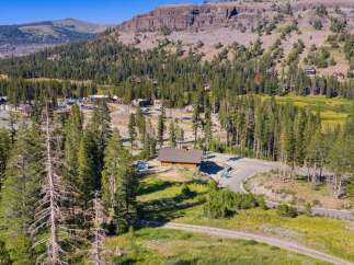 Discover this stunning mountain property nestled amidst towering pine trees and rolling hills.