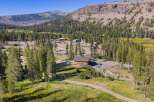 Nestled amidst a serene pine forest and towering mountains, this property offers a unique blend of natural beauty and potential.