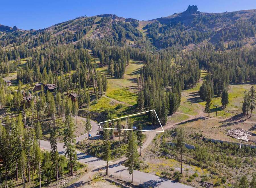 Nestled amidst a lush pine forest, this property offers a serene mountain retreat with stunning views of ski slopes and rugged peaks.