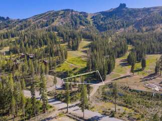 Nestled amidst a lush pine forest, this property offers a serene mountain retreat with stunning views of ski slopes and rugged peaks.