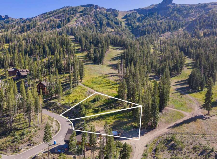 Nestled amidst a lush pine forest, this property offers a serene mountain retreat with stunning views of ski slopes and rugged peaks.