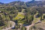 Nestled amidst a lush pine forest, this property offers a serene mountain retreat with stunning views of ski slopes and rugged peaks.