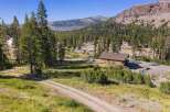 Nestled amidst towering pine trees and a majestic mountain backdrop, this property offers a serene escape.