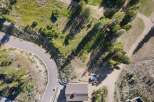 Discover this stunning aerial view of a property nestled amidst lush greenery and mature trees.