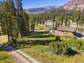 Nestled amidst a serene mountain landscape, this property offers a unique blend of natural beauty and potential.