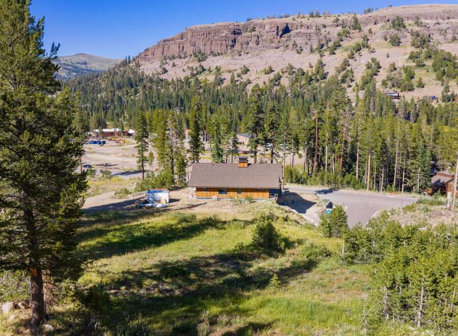 Nestled amidst a serene mountain landscape, this charming wooden home offers a tranquil retreat.