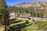 Nestled amidst a serene mountain landscape, this charming wooden home offers a tranquil retreat.