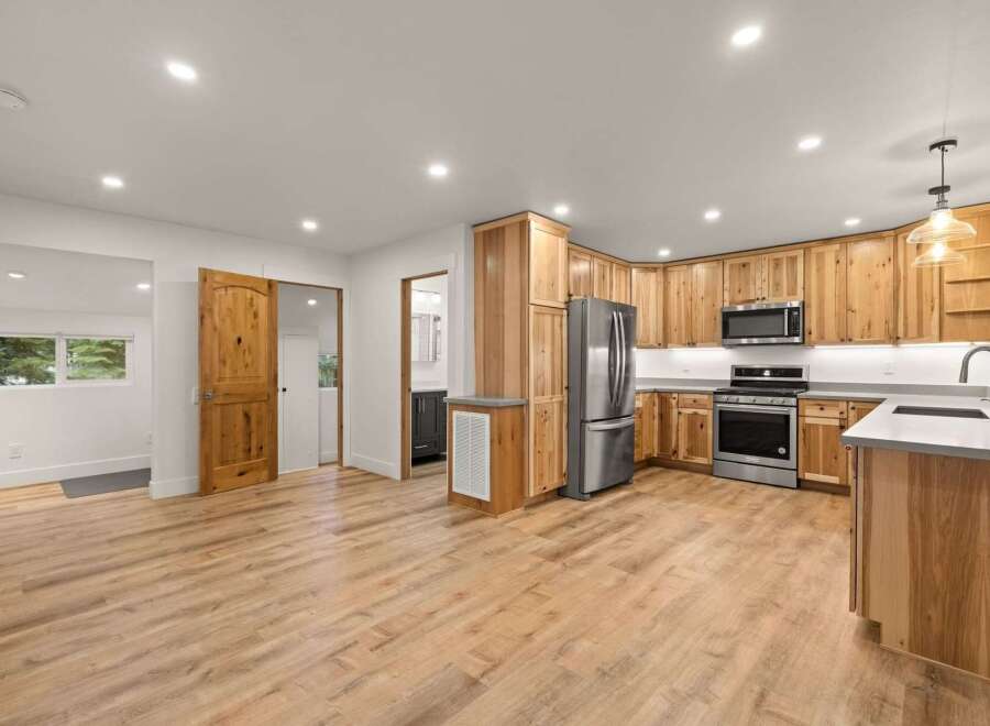 Discover this beautifully renovated kitchen featuring warm, natural wood cabinetry and sleek stainless steel appliances.