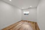 Discover this bright and airy room featuring pristine white walls and a modern wood-look floor.