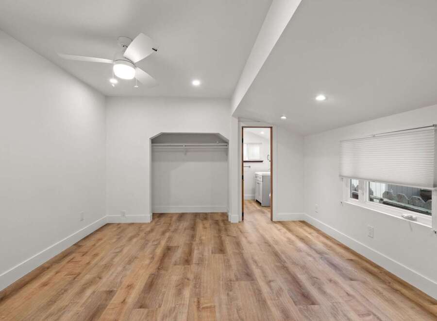 Discover this charming bedroom featuring a modern ceiling fan and recessed lighting for optimal ambiance.